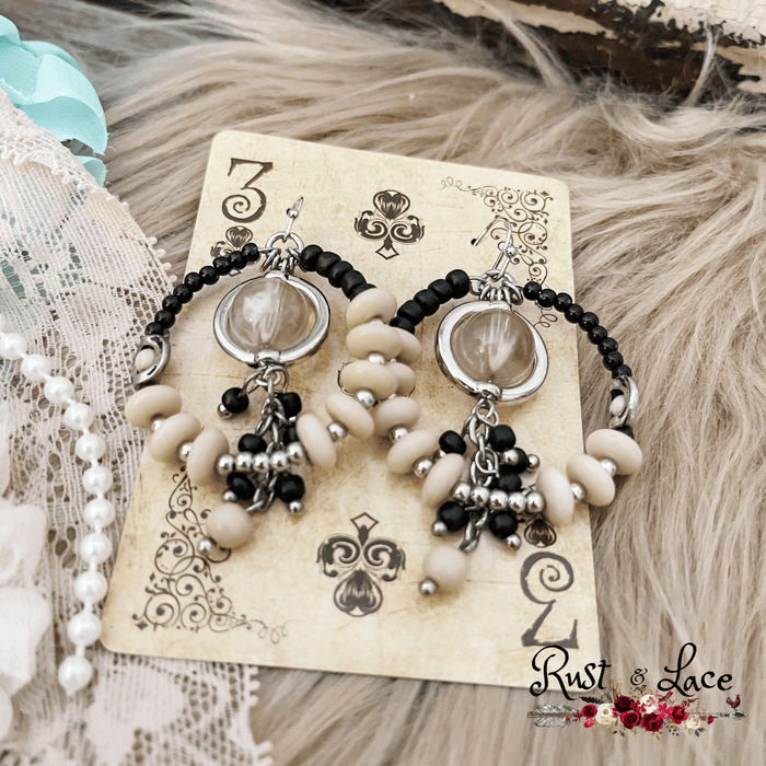 Black and ivory circle shaped earrings with a beaded center